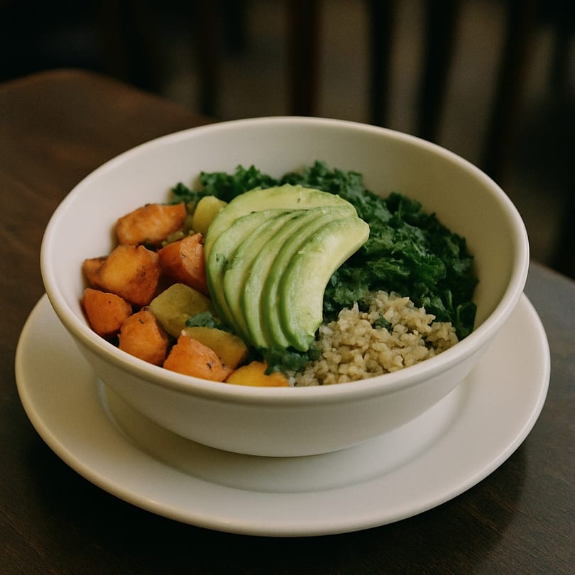 A brunch bowl from Wooden Spoon with kale, avocado, sweet potatoes, and quinoa.